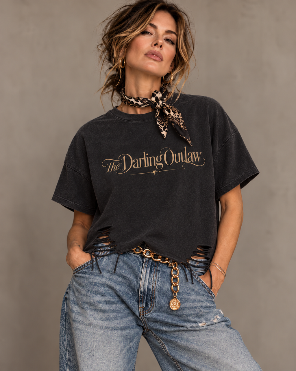 Distressed raw hem detail of The Darling Outlaw black graphic tee