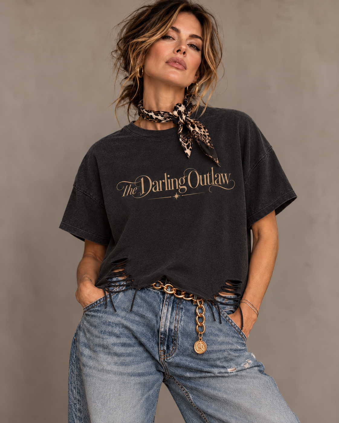 Distressed raw hem detail of The Darling Outlaw black graphic tee